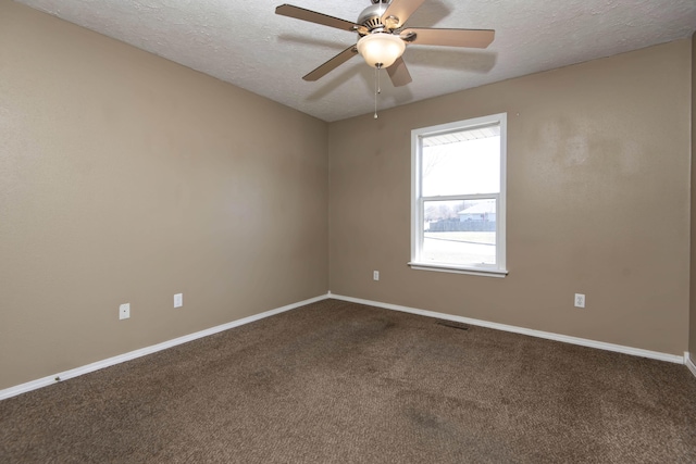 empty room with carpet floors, visible vents, a textured ceiling, and baseboards