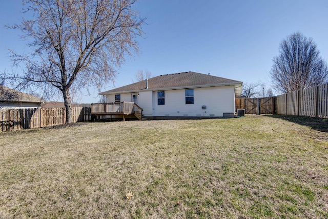 back of property featuring a deck, central AC unit, a lawn, and a fenced backyard