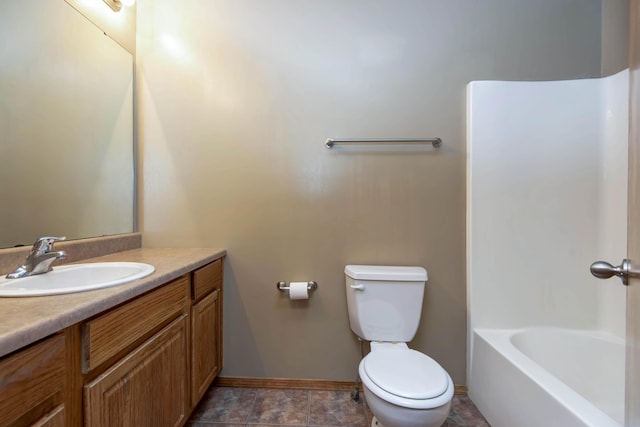 full bath with toilet, baseboards, and vanity