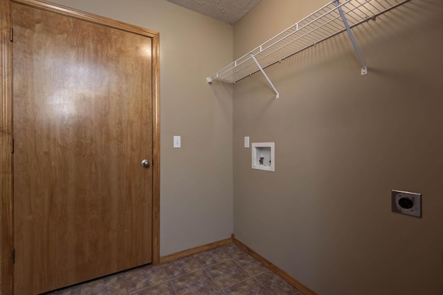 laundry room featuring laundry area, baseboards, a textured ceiling, hookup for an electric dryer, and washer hookup