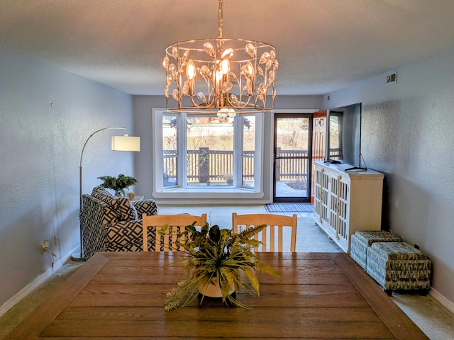 dining room with visible vents, a textured wall, a textured ceiling, and baseboards