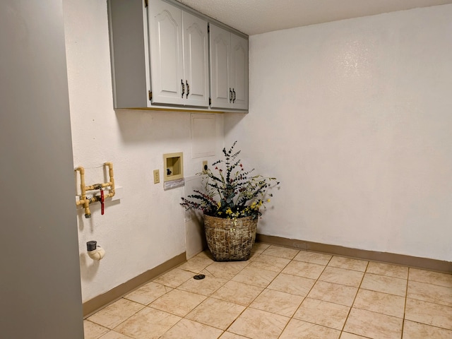 clothes washing area featuring cabinet space, baseboards, washer hookup, and electric dryer hookup