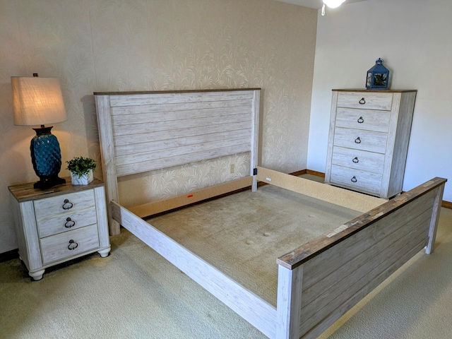 carpeted bedroom featuring baseboards and wallpapered walls