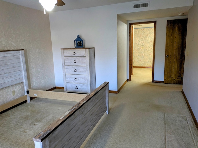 unfurnished bedroom with wallpapered walls, baseboards, visible vents, and carpet flooring