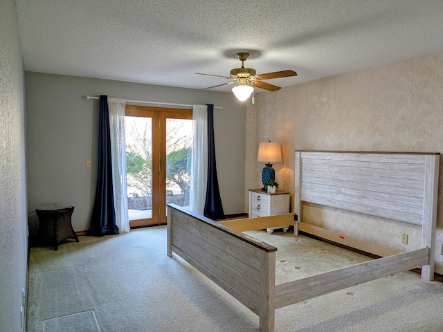 bedroom with access to exterior, a ceiling fan, carpet flooring, a textured ceiling, and wallpapered walls