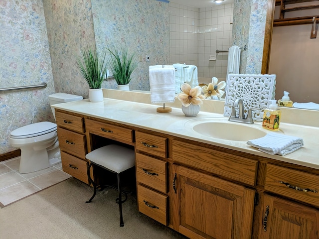 full bathroom with tile patterned flooring, toilet, vanity, tiled shower, and wallpapered walls