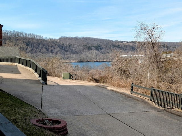 exterior space with a water view and a view of trees