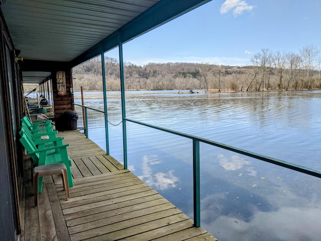 dock area with a water view and a forest view