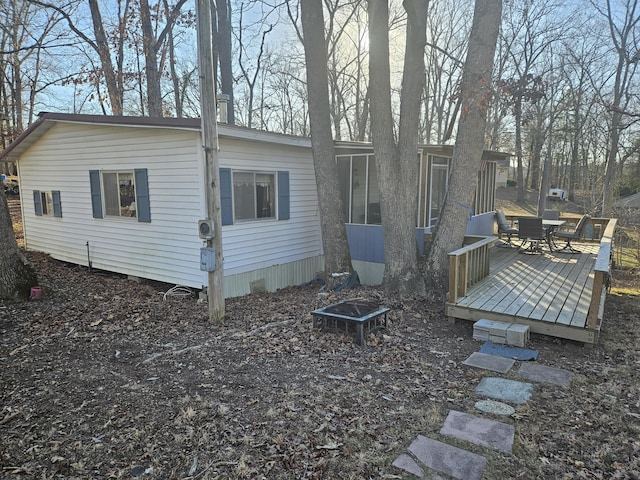 back of property with a wooden deck