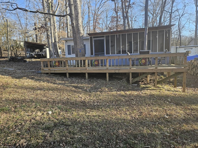 rear view of property featuring a sunroom