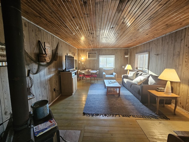 living room featuring wooden ceiling, hardwood / wood-style flooring, an AC wall unit, and wood walls