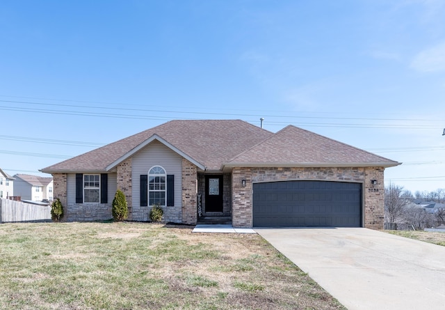 ranch-style house featuring driveway, a shingled roof, a garage, and a front yard