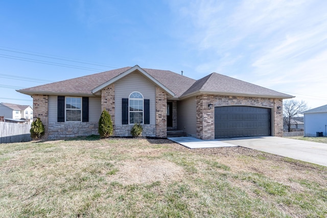 single story home with a shingled roof, concrete driveway, an attached garage, a front lawn, and brick siding