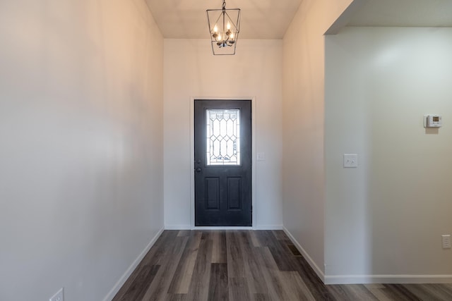 entrance foyer featuring dark wood-style floors, baseboards, and an inviting chandelier