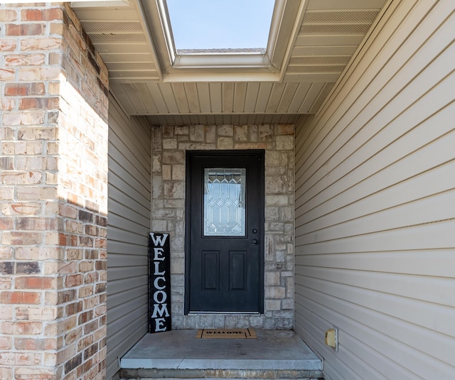 entrance to property with brick siding