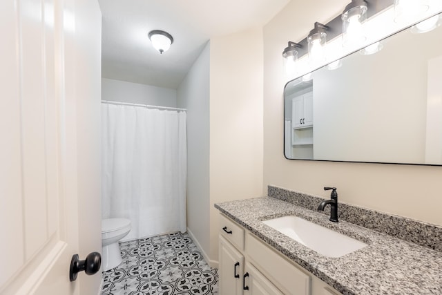 full bath with tile patterned flooring, curtained shower, vanity, and toilet