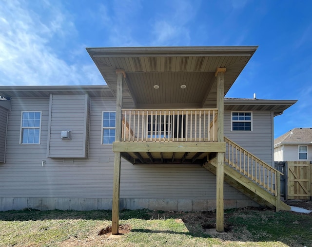 rear view of house with stairs and fence