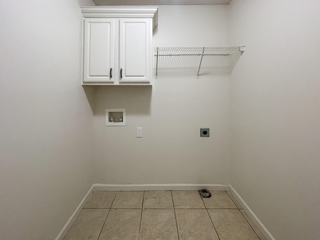 laundry area featuring cabinet space, baseboards, washer hookup, and electric dryer hookup