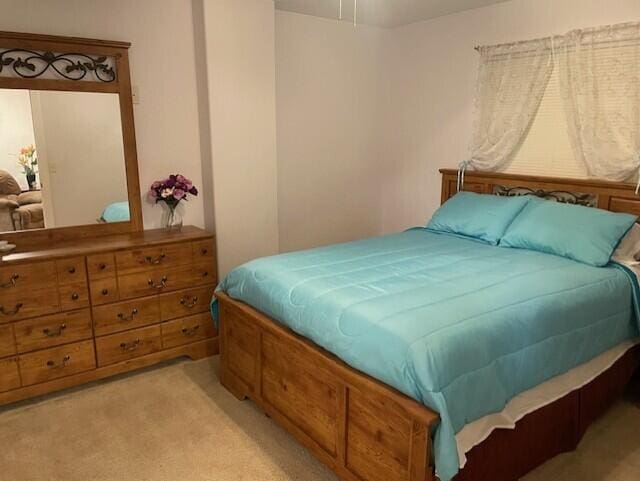 bedroom featuring light colored carpet