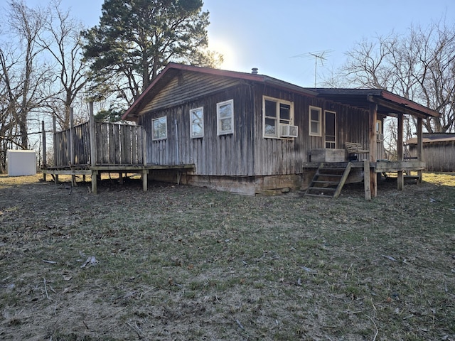 view of side of home with cooling unit and a wooden deck