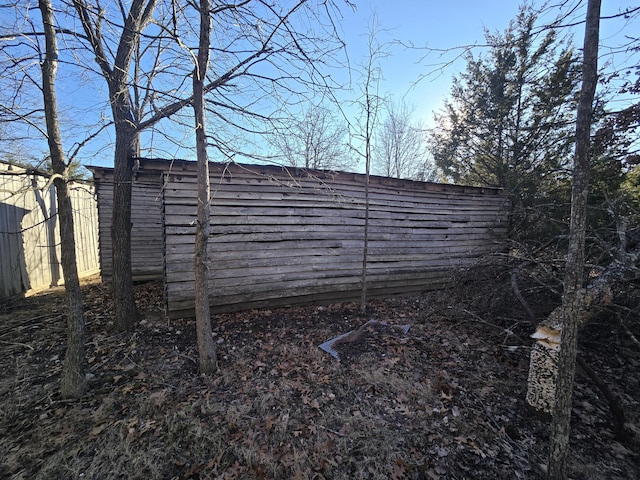 exterior space with an outbuilding and fence