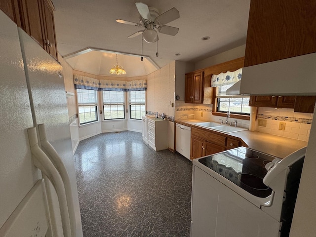 kitchen featuring white appliances, plenty of natural light, a sink, and tasteful backsplash