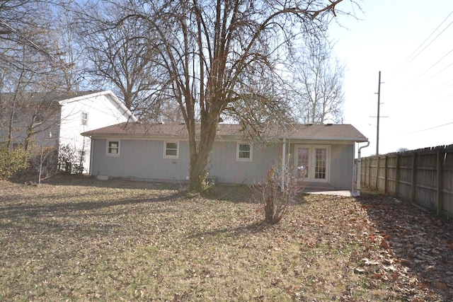 back of property with french doors and fence