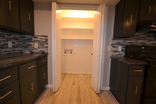 kitchen featuring black range with electric stovetop, baseboards, ventilation hood, light wood finished floors, and tasteful backsplash