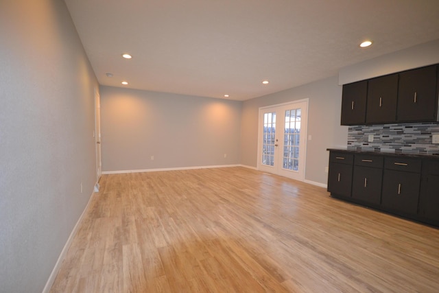 unfurnished living room with light wood-type flooring, french doors, baseboards, and recessed lighting