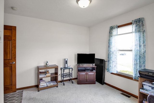 home office featuring baseboards, visible vents, light colored carpet, and a healthy amount of sunlight