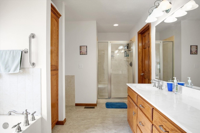 full bath featuring a bath, a shower stall, vanity, and baseboards