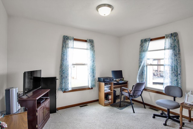 office space with light carpet, visible vents, and baseboards