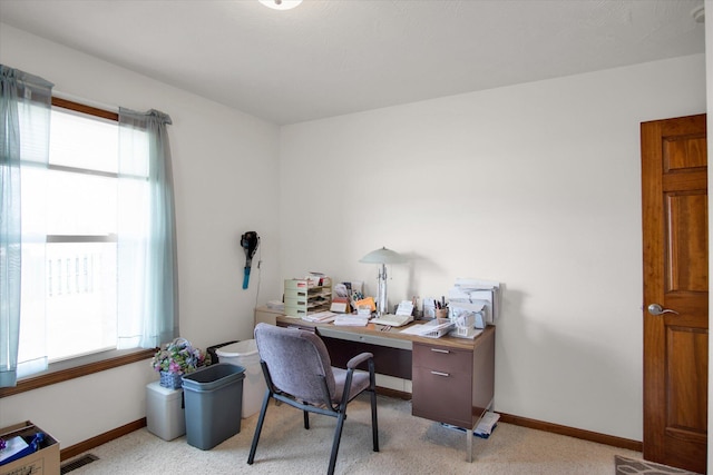 office with light colored carpet, visible vents, plenty of natural light, and baseboards