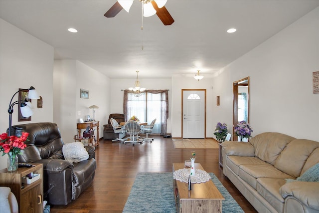 living room featuring ceiling fan with notable chandelier, dark wood-style flooring, and recessed lighting