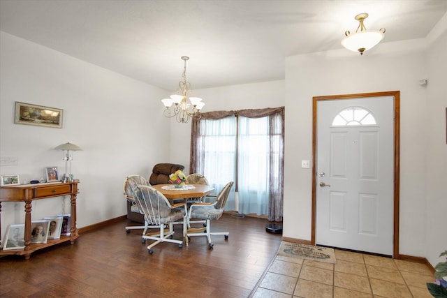 dining space with a chandelier, light wood-type flooring, and baseboards