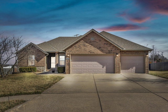 ranch-style house with driveway, roof with shingles, an attached garage, and fence