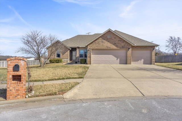 view of front facade featuring driveway, brick siding, a front lawn, and fence