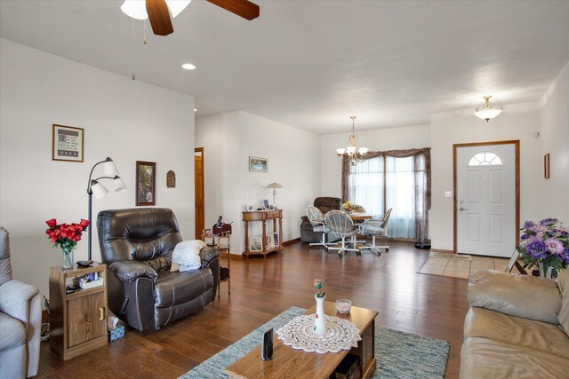 living area featuring ceiling fan with notable chandelier, recessed lighting, baseboards, and wood finished floors