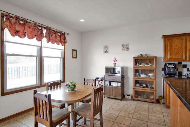 dining room with light tile patterned floors and baseboards