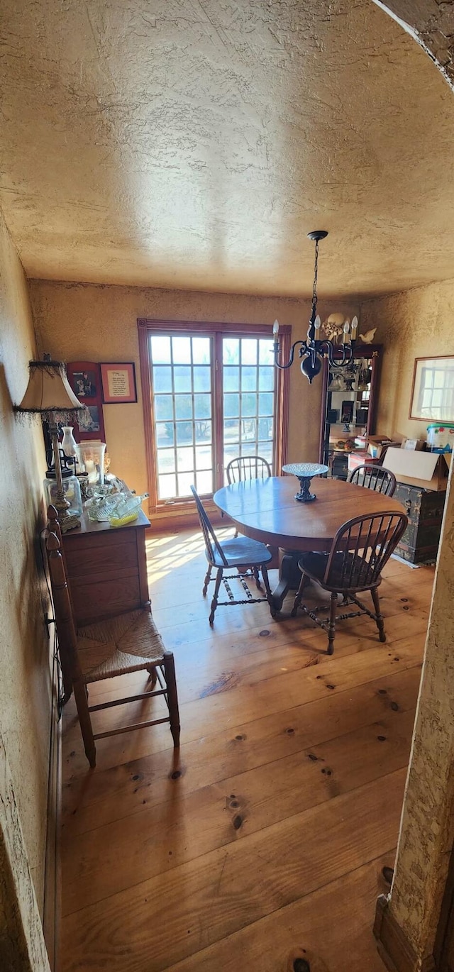 dining space with wood-type flooring