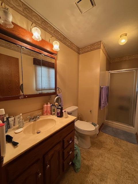 full bathroom featuring visible vents, toilet, a shower stall, and vanity