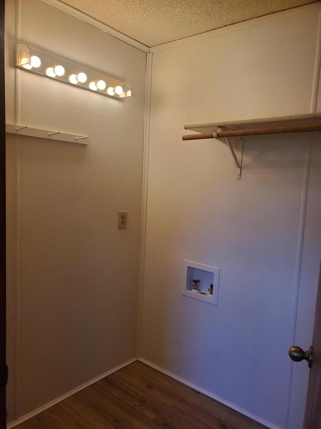 washroom featuring dark wood-type flooring, hookup for a washing machine, and baseboards