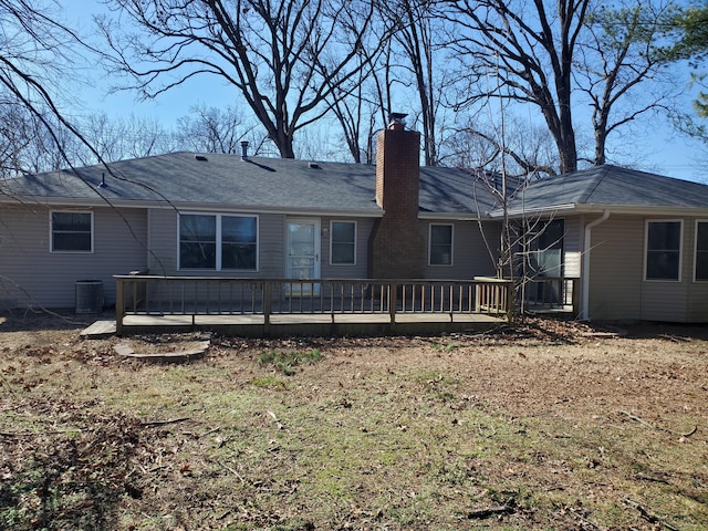 rear view of house with a chimney and a wooden deck