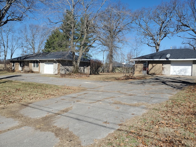 view of side of property with driveway and an attached garage