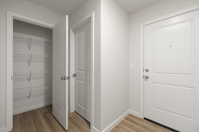 interior space with light wood-style floors and baseboards