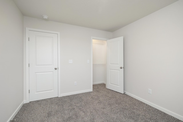 unfurnished bedroom with baseboards and carpet