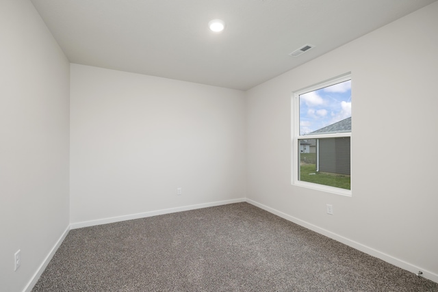 empty room featuring visible vents, baseboards, and carpet floors