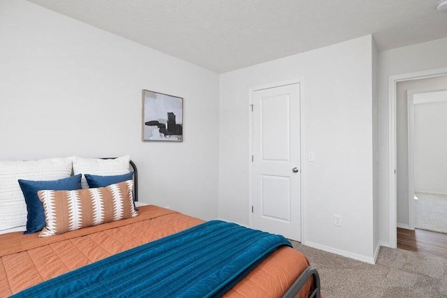 carpeted bedroom with baseboards