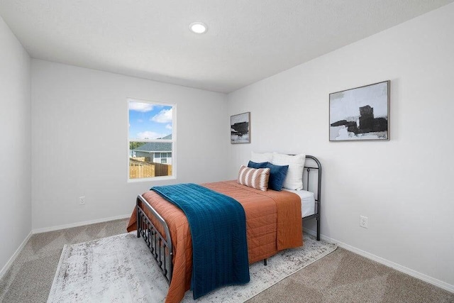 bedroom featuring carpet floors and baseboards