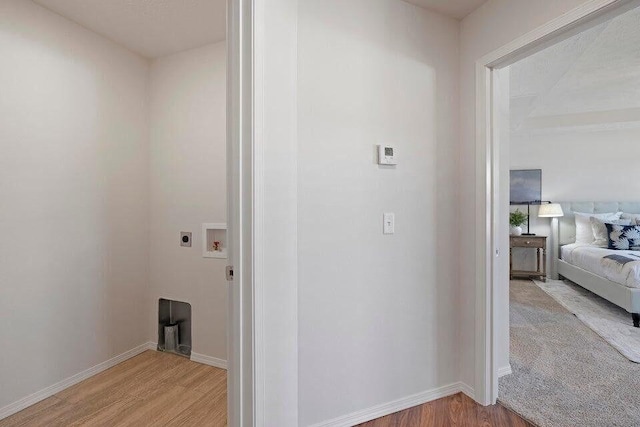 interior space featuring light wood-style floors, baseboards, washer hookup, and electric dryer hookup